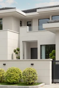 Modern residential exterior featuring concrete and glass materials