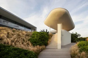 Modern house with minimalist design featuring concrete, glass, and wood materials.