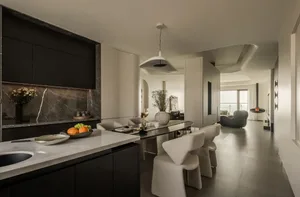 Contemporary kitchen interior featuring marble countertops and concrete walls.