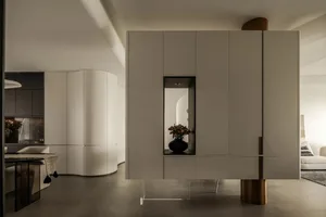 Modern minimalist living room featuring metallic accents and sleek design elements.