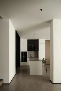 Modern kitchen featuring a white floating island with a waterfall countertop and built-in storage.