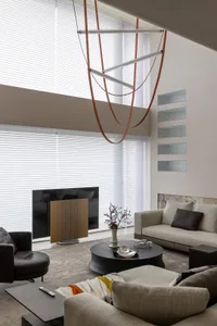 A modern living room featuring concrete elements and leather furniture.