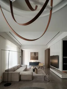 Modern minimalist living room with concrete, leather, and wood finishes