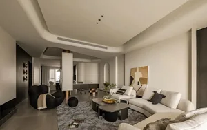 A modern, neutral-toned living room featuring contemporary furniture and minimalist decor.