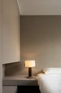 Minimalist bedroom with wooden bed and cloth mattress, showcasing modern interior design elements.