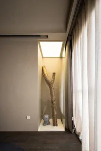 A minimalist bedroom featuring a wooden trunk as a unique decorative element.