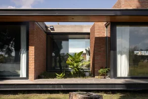 Modern house with a minimalist exterior featuring a combination of brick, glass, and concrete materials.