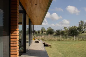 A modern exterior space featuring concrete and wood elements.