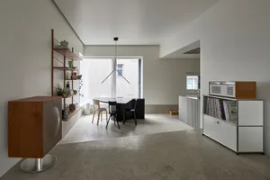 A modern kitchen with a concrete floor and minimalist design.