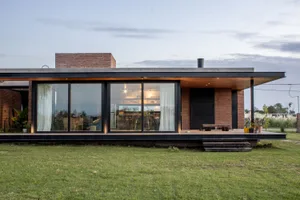 A minimalist house with brick and glass exterior.