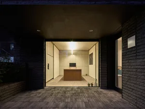 A minimalist office space featuring a concrete table and minimalist design elements.