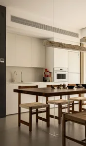 Minimalist residential kitchen featuring wood furniture and white appliances.