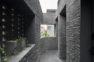 A photograph of a modern interior space with concrete walls, showing a minimalist design aesthetic.
