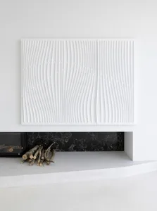 Modern minimalist interior design featuring textured concrete floor and marble fireplace with firewood.