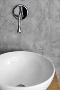 Minimalist bathroom featuring a concrete vessel sink