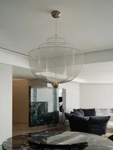 A modern living room with a metal netting chandelier hanging from the ceiling.