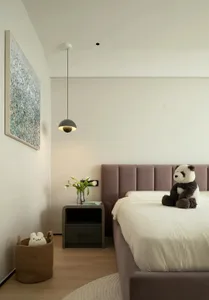 Modern minimalist bedroom with a purple upholstered bed, floating grey pendant light, and minimalistic decor.