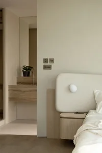 Modern minimalist bedroom featuring neutral tones and clean lines