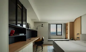 A minimalist bedroom featuring wood and glass elements.