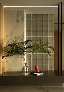 A minimalist interior featuring marble and glass block walls.