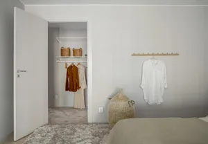 A minimalist bedroom with neutral-toned fabrics and a touch of wood.