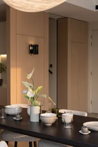 A well-lit, modern dining room with wooden walls and ceramic tableware.