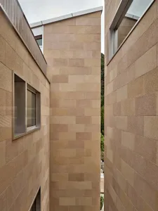 Modern exterior with stone tiles on the walls of a house.