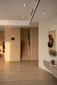 Modern interior design featuring a minimalist wooden hallway with sleek lines and warm, natural wood tones.