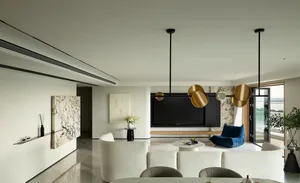 A modern living room with white marble accents and a minimalist design.