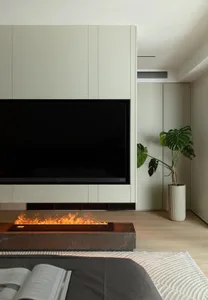 Modern living room featuring a marble fireplace, floating cabinets, and a potted plant.