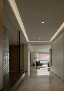 Modern minimalist residential interior with marble, glass, and wood elements.
