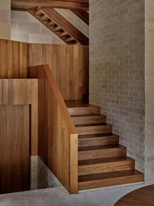 Modern, industrial-style stairs crafted from dark wood, featuring a minimalist design and geometric steps.