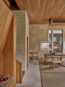 A modern residential space featuring wooden walls, floors, and furniture.