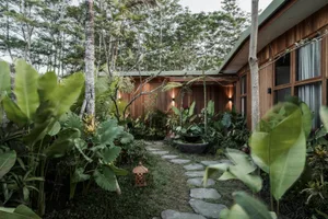 A modern interior space featuring stone pavers, natural decorative containers, and plants.
