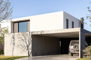 A minimalist, contemporary house with a concrete exterior.