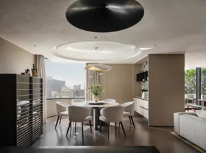 Modern dining room featuring glass and marble surfaces, with concrete flooring and fabric chairs.