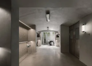 A modern industrial storefront with concrete walls and minimalist design features.