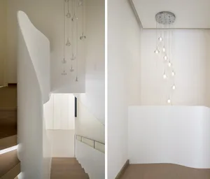 Modern interior design featuring a staircase with glass pendant lights.