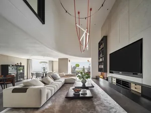 A modern living room featuring neutral-toned furniture and decor.