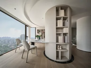 A modern living room with a white color palette, featuring curved white walls, a large window, and a contemporary table.