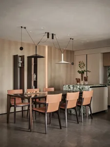 Modern dining room featuring marble table and wooden chairs surrounded by wooden walls.
