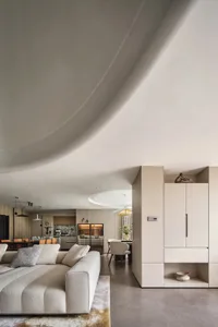 Modern minimalist residential interior with neutral tones and wood, marble, and glass materials.