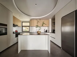 Modern kitchen with white cabinets and black countertops