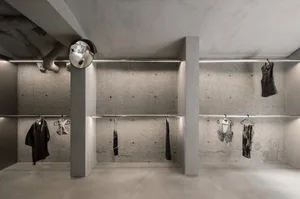 Concrete clothing display area with industrial design elements.