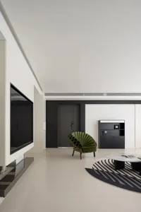 A modern living room featuring a concrete floor, minimalist furniture, and geometric patterns.