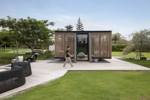 A modern minimalist pavilion with wood, glass, and stone materials
