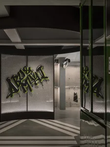 A modern retail shop featuring concrete walls with graffiti art, showcasing contemporary interior design elements.