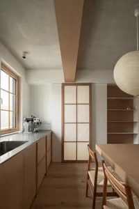 A minimalist kitchen with wooden cabinets and a window