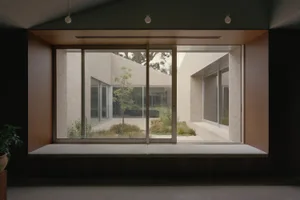 A modern living room with brick and concrete walls, floor-to-ceiling windows, and a minimalist design.