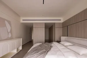 A modern minimalist bedroom with wooden paneling, a bed with a soft, light-colored headboard, and a contemporary art piece mo